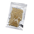 Clear front resealable mylar bag with small round beige contents