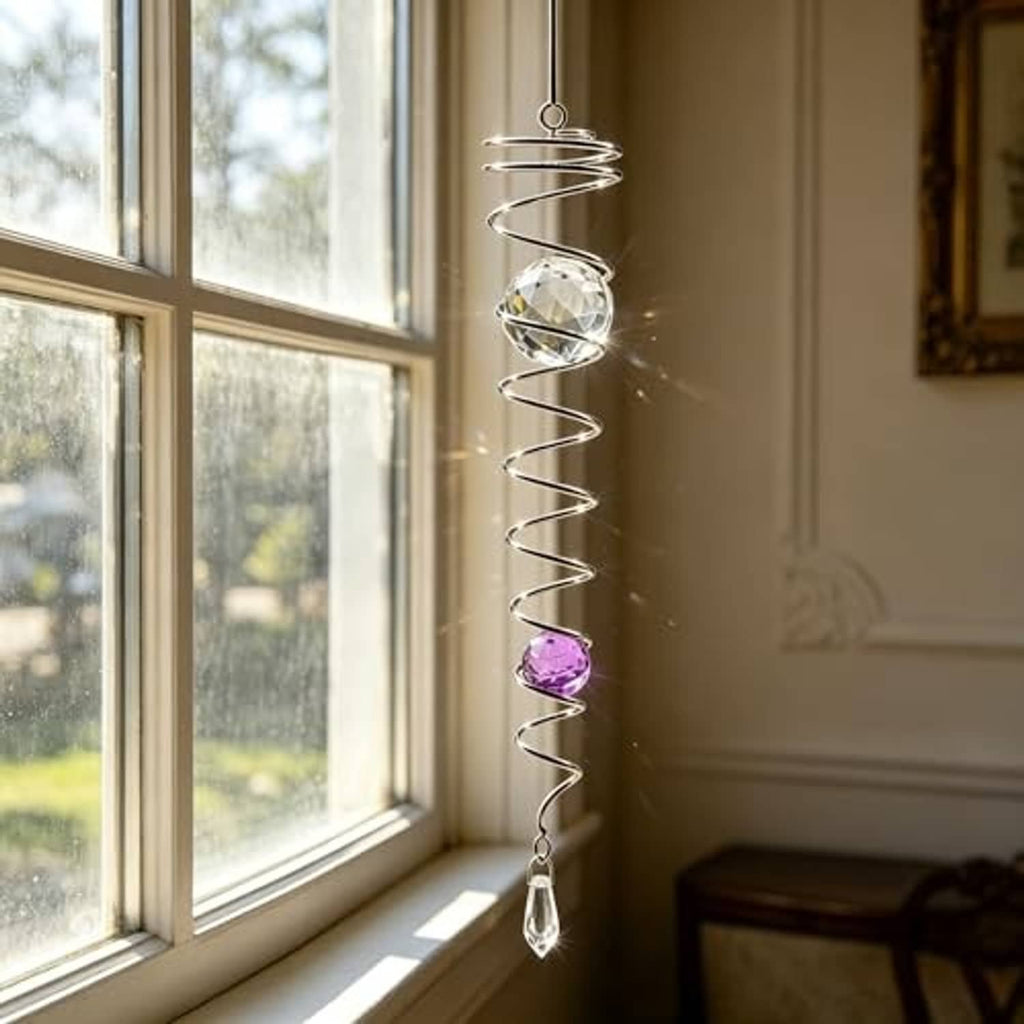 Hanging silver spiral wind spinner with clear gazing ball, purple bead, and bottom crystal drop
