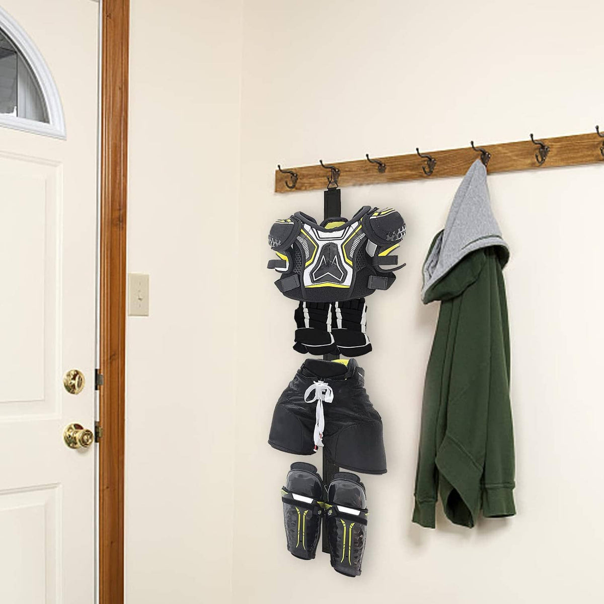 Wall-mounted hockey drying rack holding shoulder pads, shorts, and shin guards