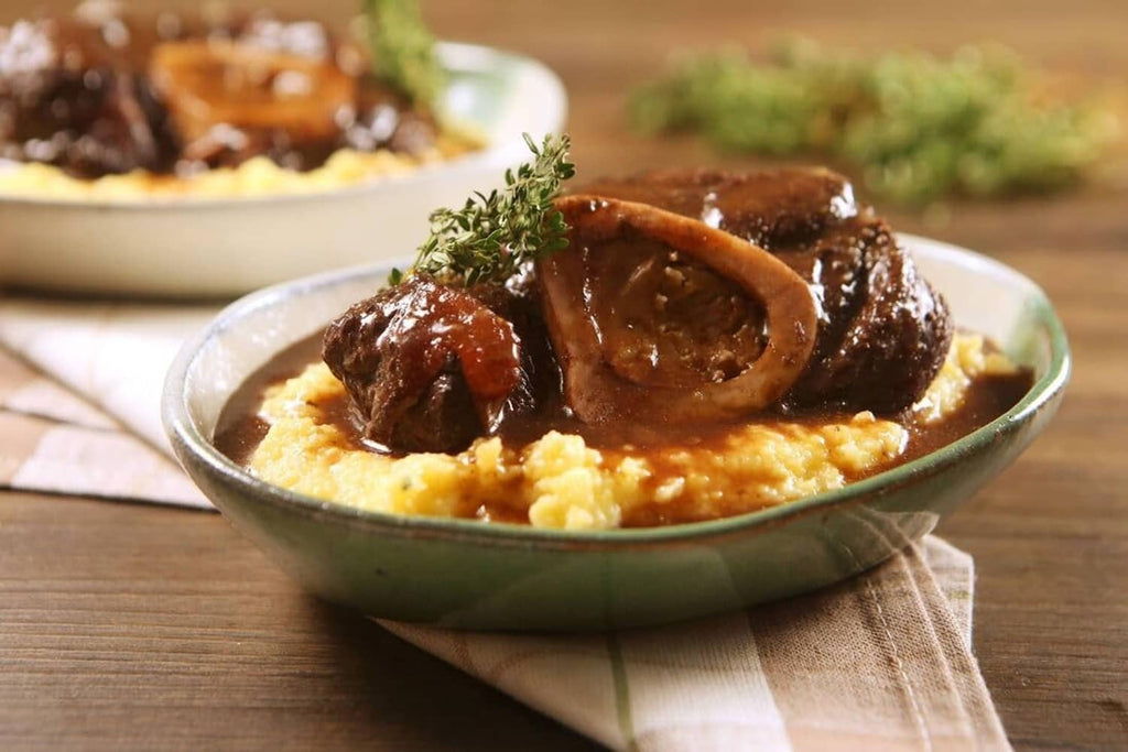 Beef pieces in roasted beef base sauce over mashed potatoes