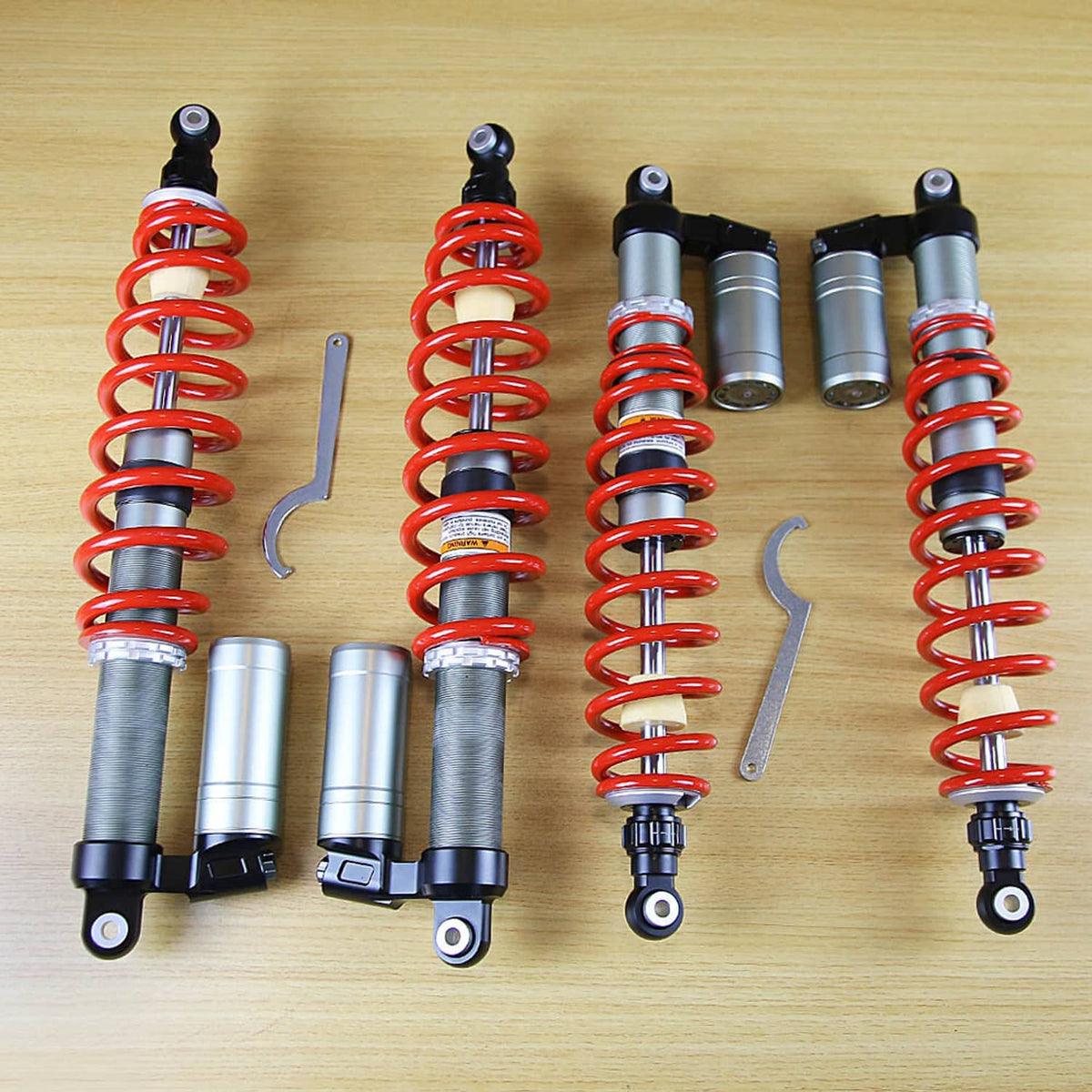 Air shock absorbers with red coil springs, silver cylinders, and black mounting brackets