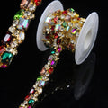 Gold rhinestone trim chain with multicolor AB crystals, wrapped on a white spool