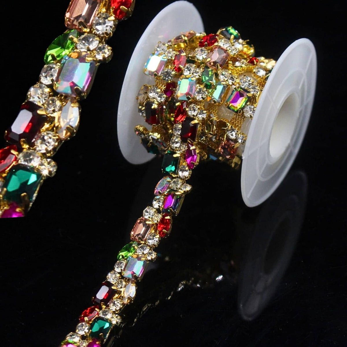 Gold rhinestone trim chain with multicolor AB crystals, wrapped on a white spool