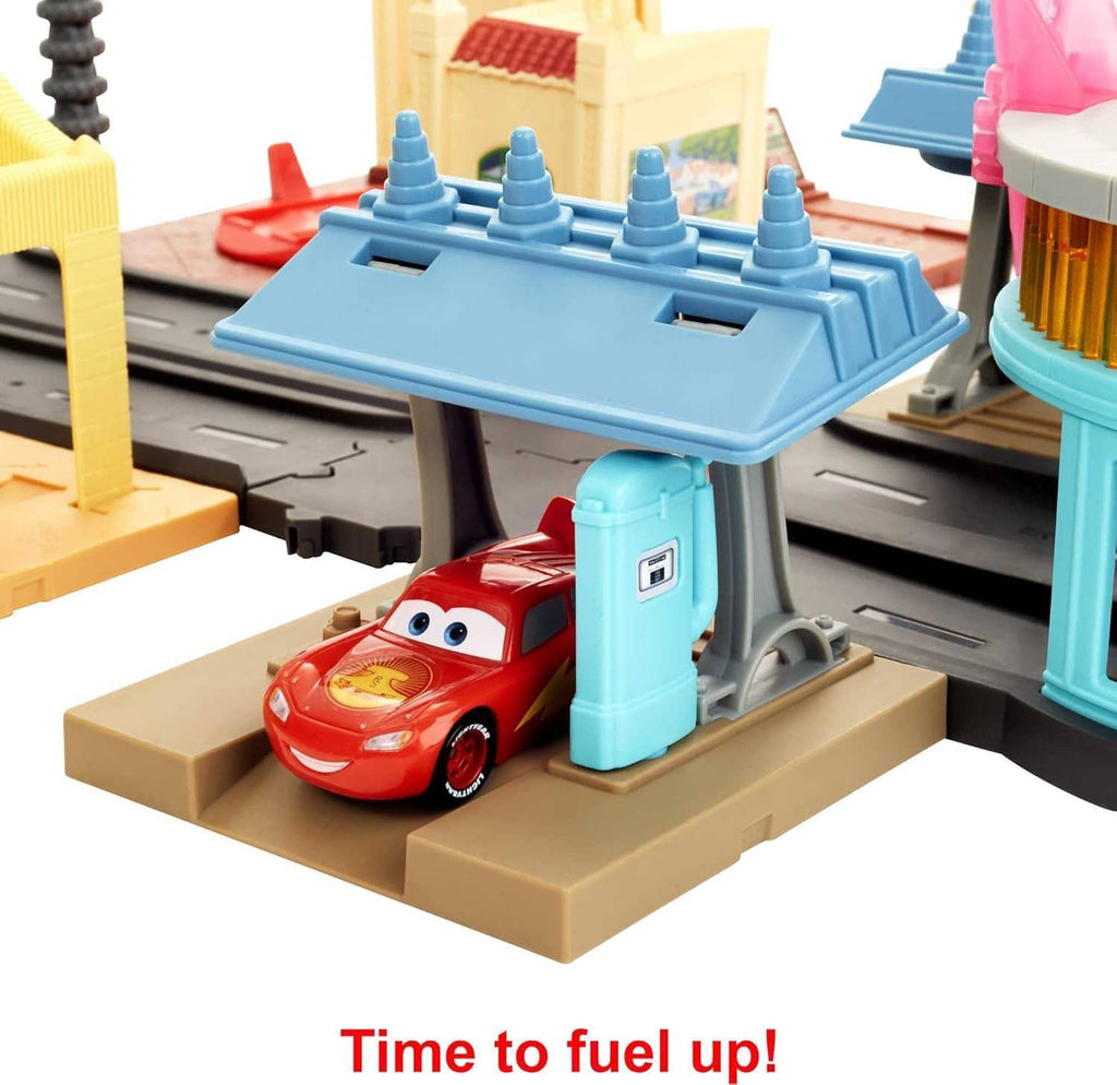Close-up of Cars toy car on blue fueling station platform with track pieces