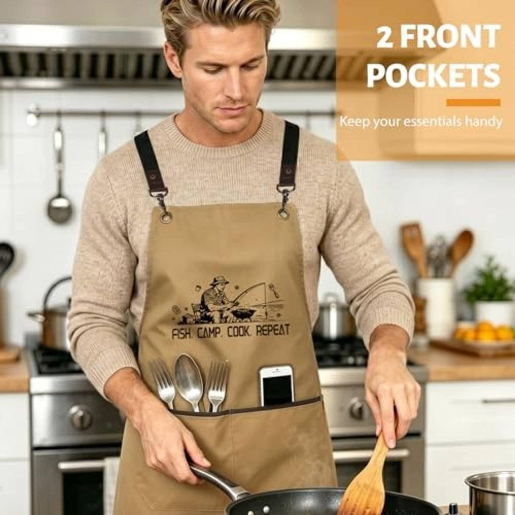Khaki cooking apron on a man, featuring “FISH. CAMP. COOK. REPEAT” and two front pockets.