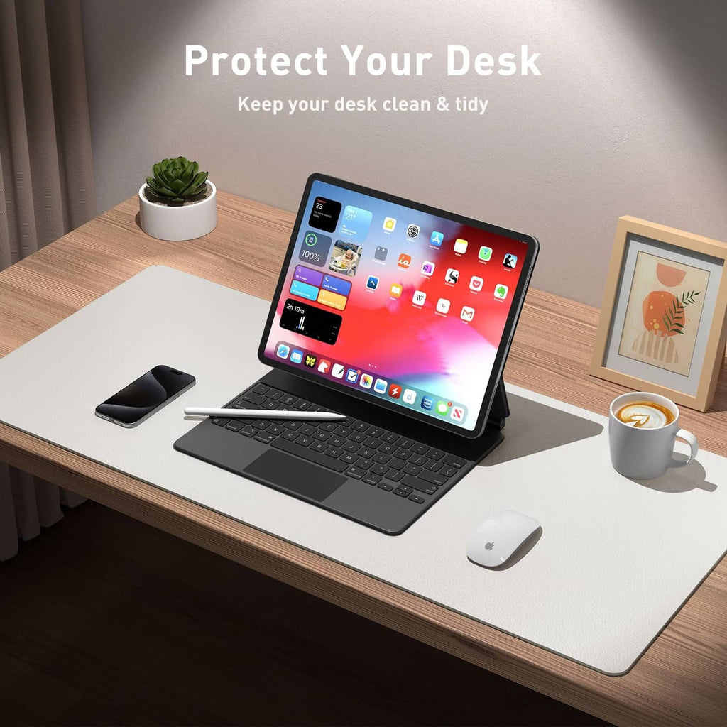 Off-white desk pad protector on wooden desk with keyboard and mouse for workspace.