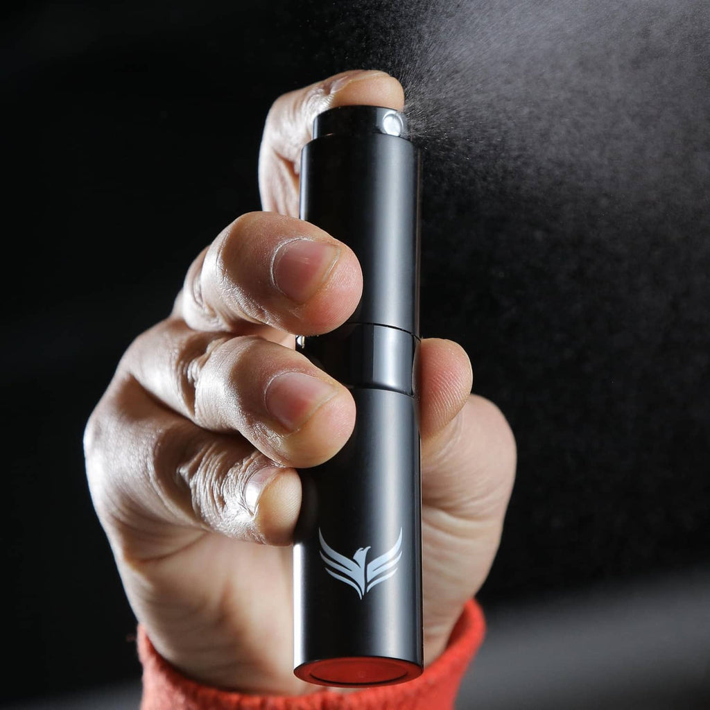 Close-up of a black RDT sprayer bottle held in a hand