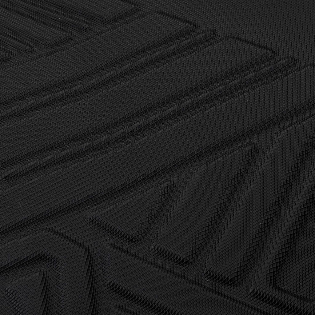 Close-up of black rubber floor mat texture with repeating diamond-pattern grip