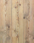 Close-up wood plank wallpaper with pale tan boards and dark knot patterns