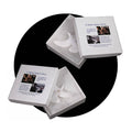 White turtle dove ornaments in a gray presentation box with two folded compartments