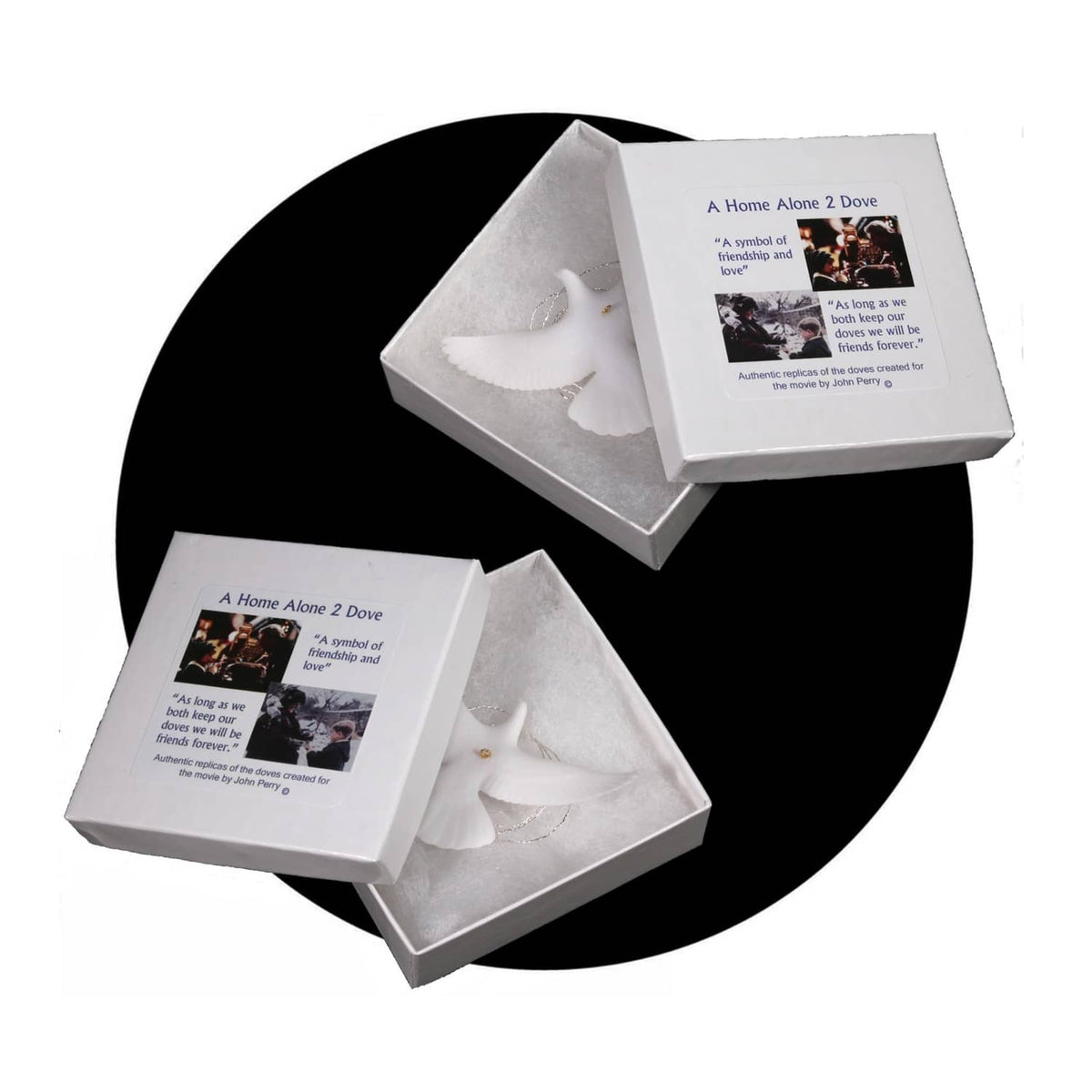 White turtle dove ornaments in a gray presentation box with two folded compartments