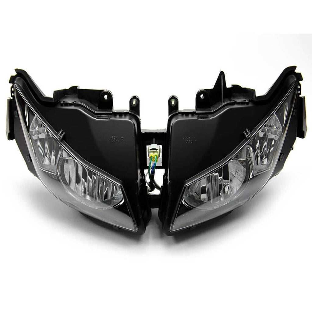 Pair of front headlights with black housings, clear lenses, and central connector