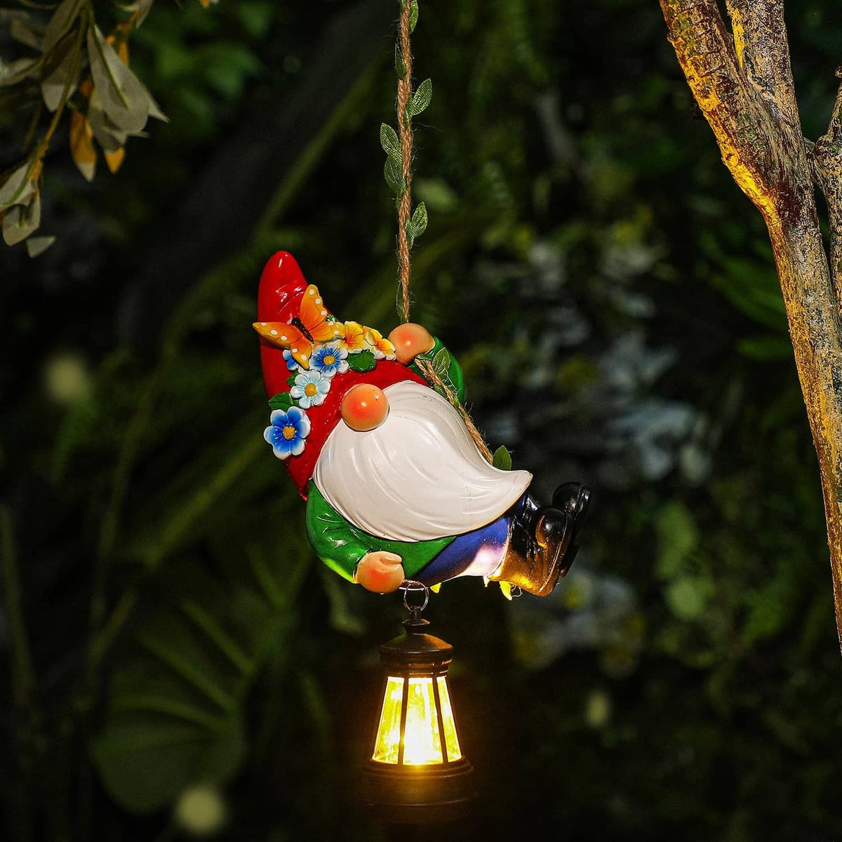 Solar hanging gnome statue with white beard, red hat, and glowing lantern