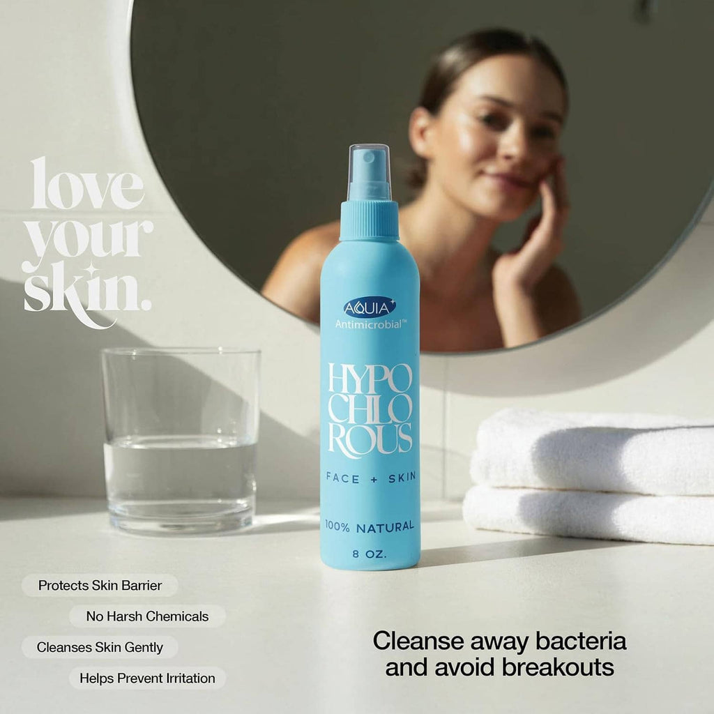Hypochlorous acid spray bottle on counter with glass of water and folded towel