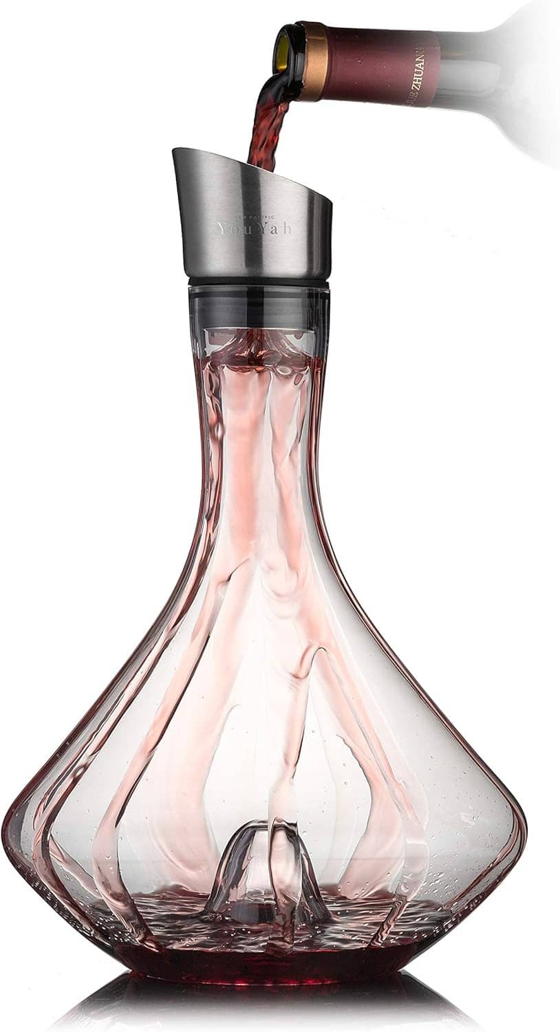 Glass wine decanter with black top and aerator, red-tinted interior