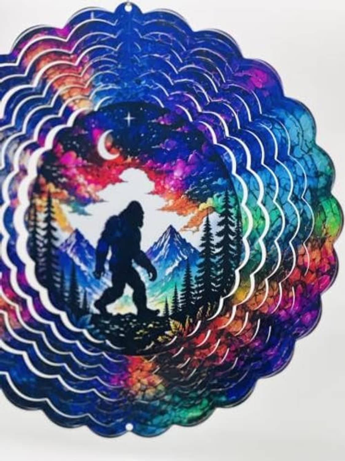 Angled view of the Bigfoot wind spinner with layered scallop edge in rainbow colors
