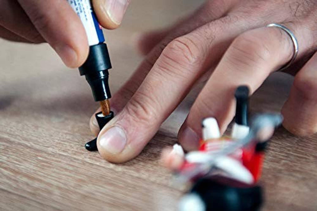 Cyanoacrylate adhesive tip applying glue to small pieces on a surface