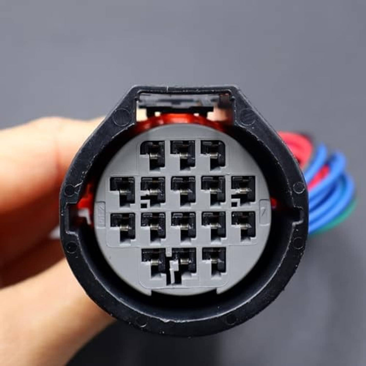 Headlight connector pigtail close-up of multi-pin socket in round black housing