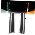 Pair turn signal lights with clear lens and black housings, front view, unlit