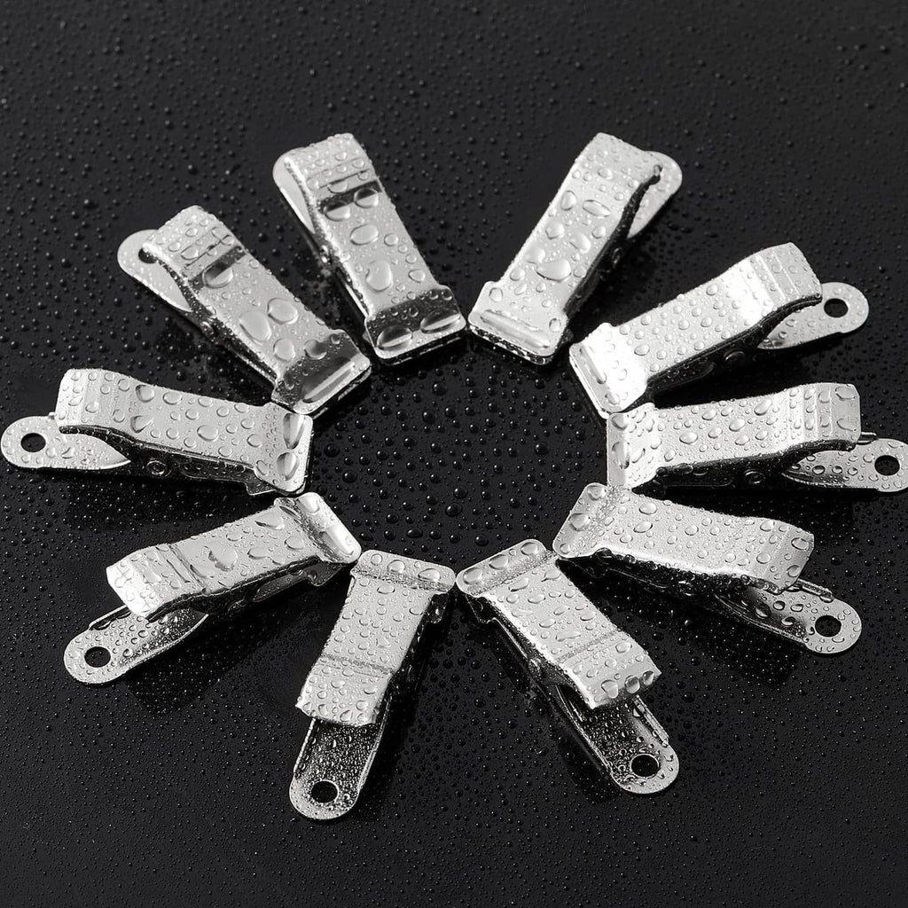 Silver metal spring clamps arranged in a circle, shown with water droplets
