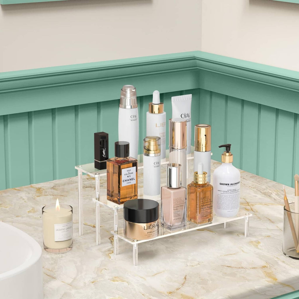 Clear acrylic 3-tier organizer stand holding skincare bottles on three levels