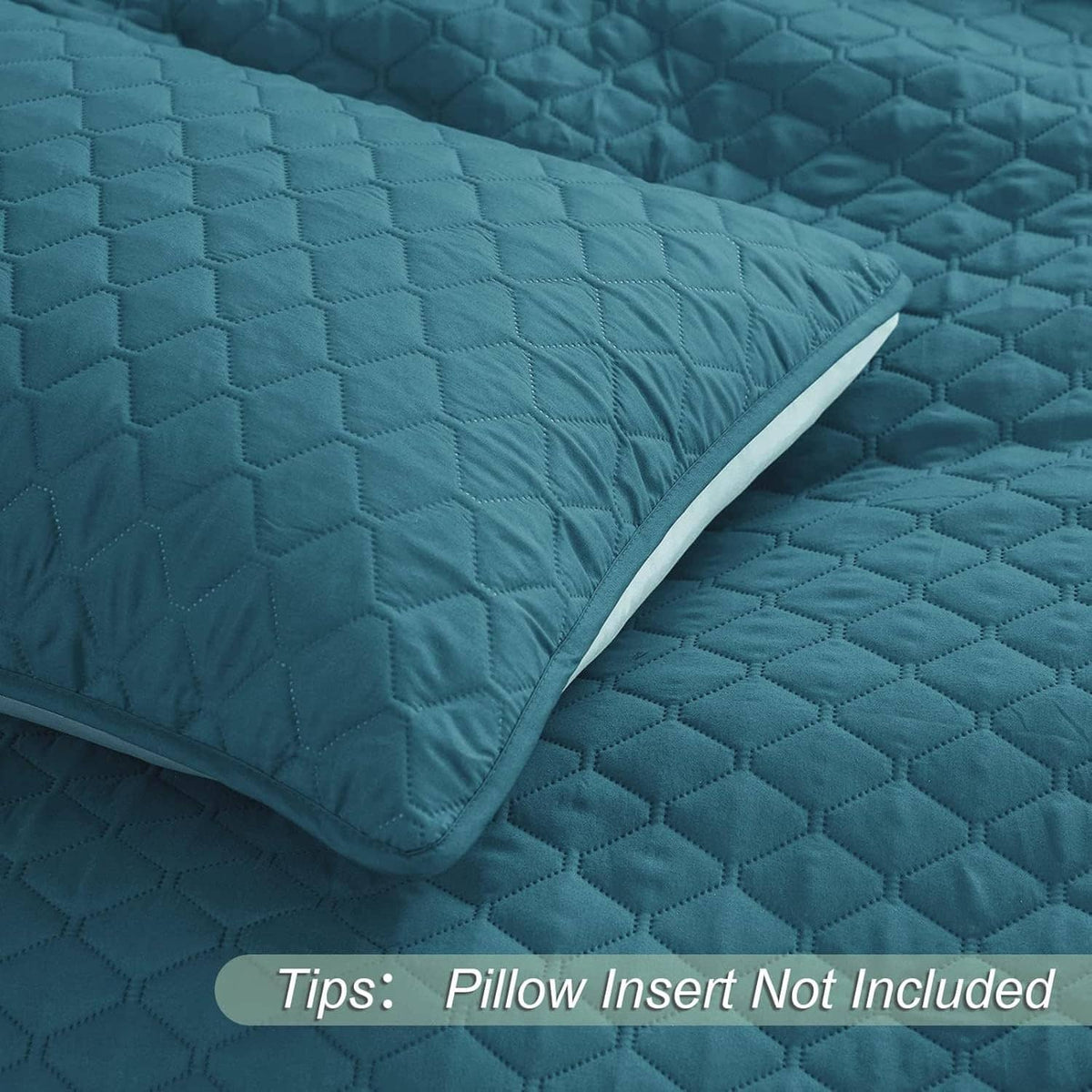 Teal quilt with raised diamond quilting, folded corner close-up