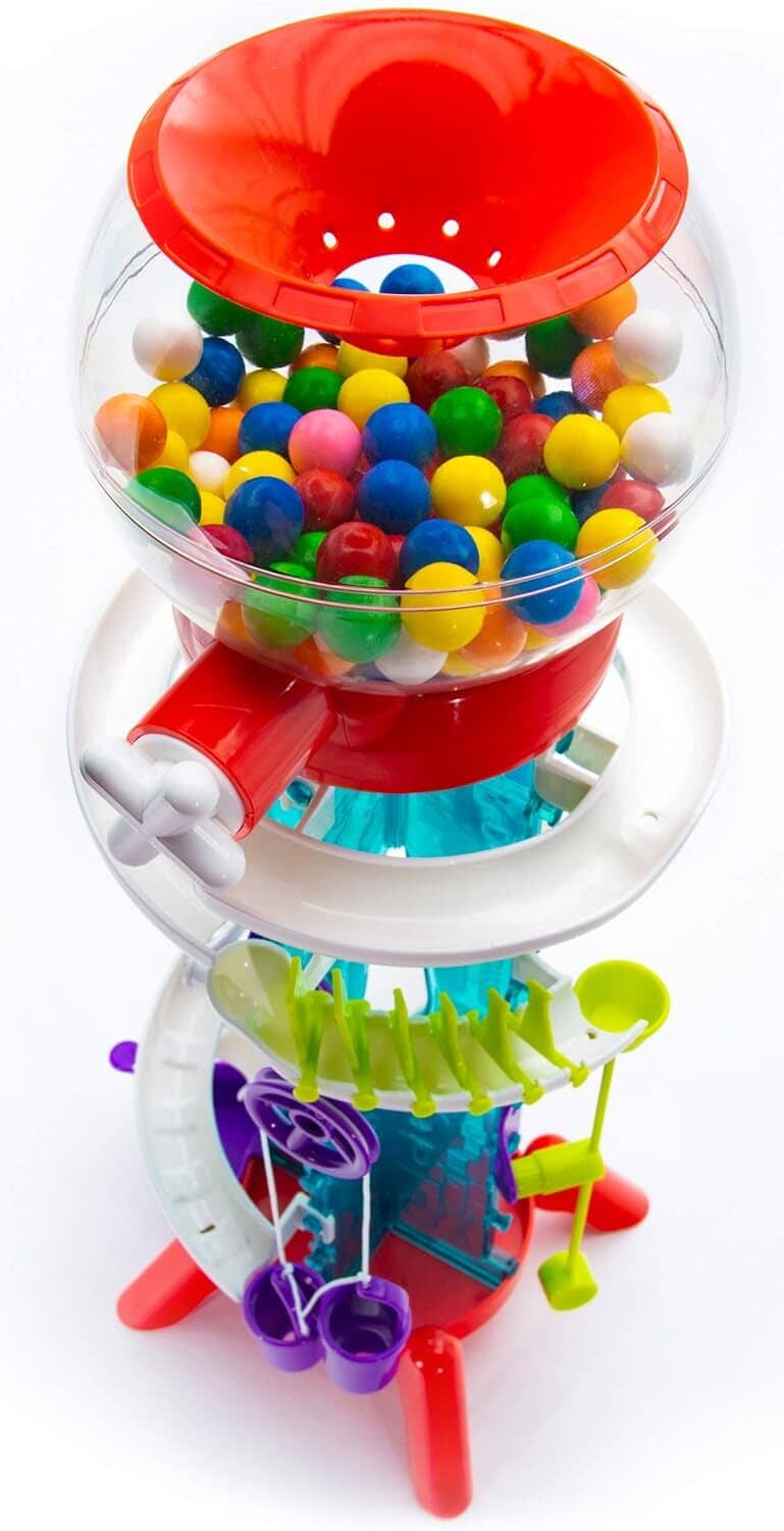 Bubble gum machine top dome filled with colorful balls and red chute, stacked toy pieces