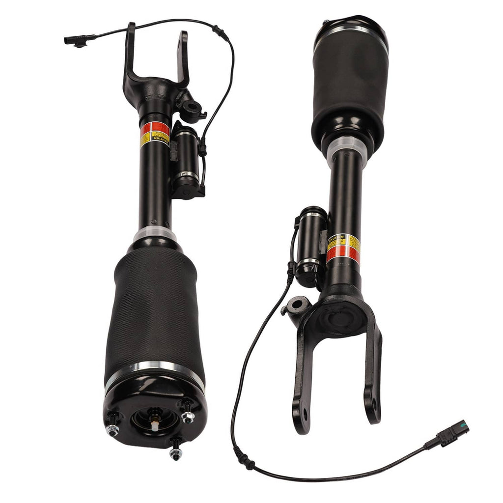 Front air suspension strut pair showing top caps, hoses, and electrical connector leads