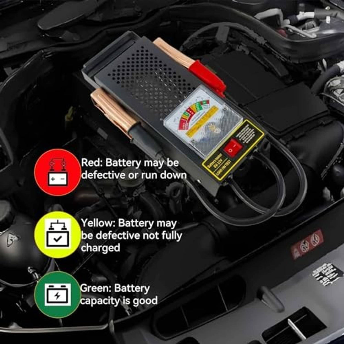 Car battery load tester connected in engine bay with red/black clamps and leads