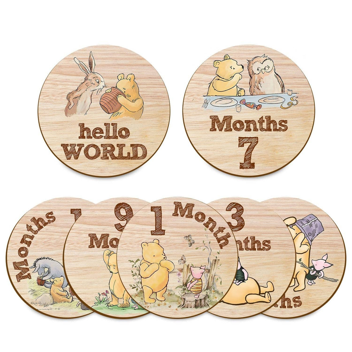 Wooden baby milestone circle signs with Winnie friends, including Hello World and month 7.