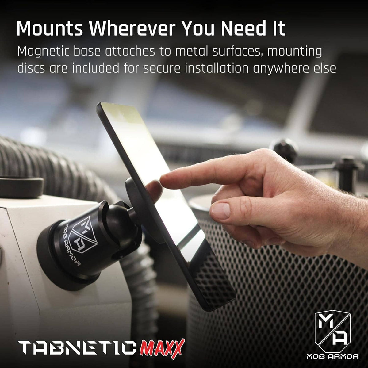 Magnetic tablet mount with round base disc on metal surface and mounted tablet