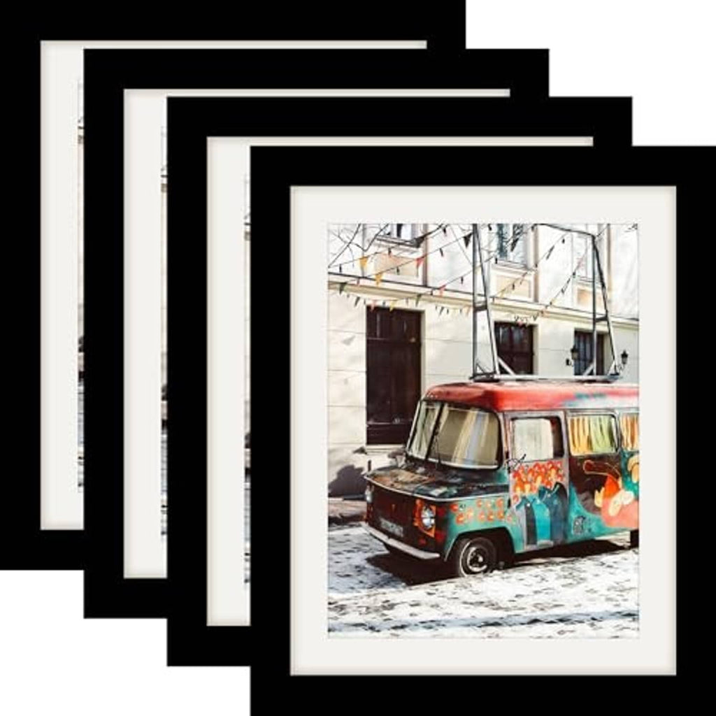 Set of four black wood picture frames, stacked with a vehicle photo in view