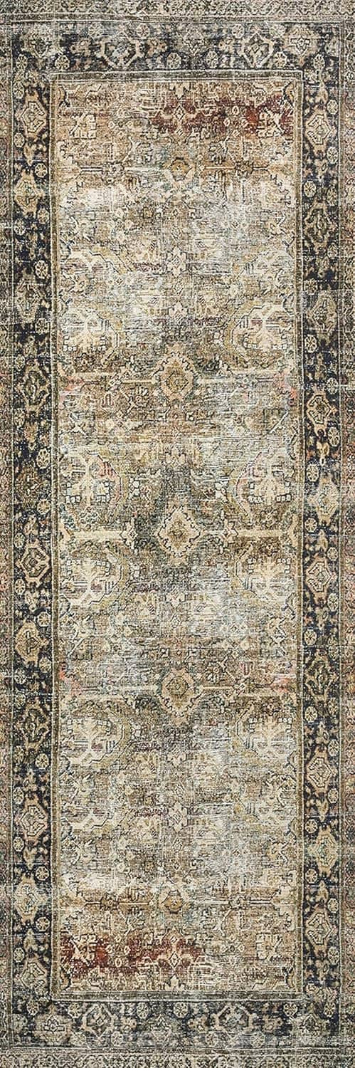 Straight-on view of vintage area rug panel with ornate frame and faded olive-charcoal pattern