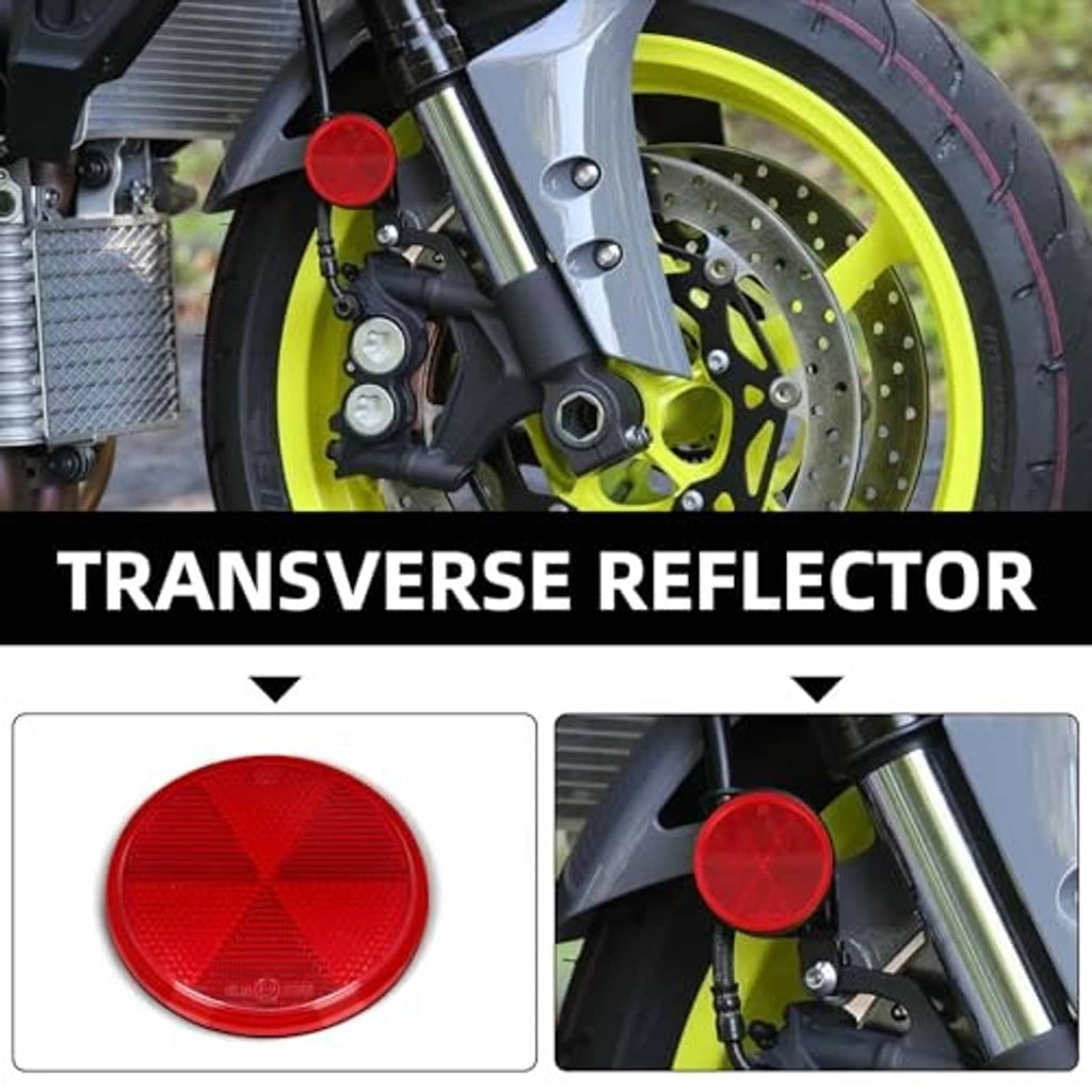 Red round self-adhesive reflector mounted on a motorcycle front fork area
