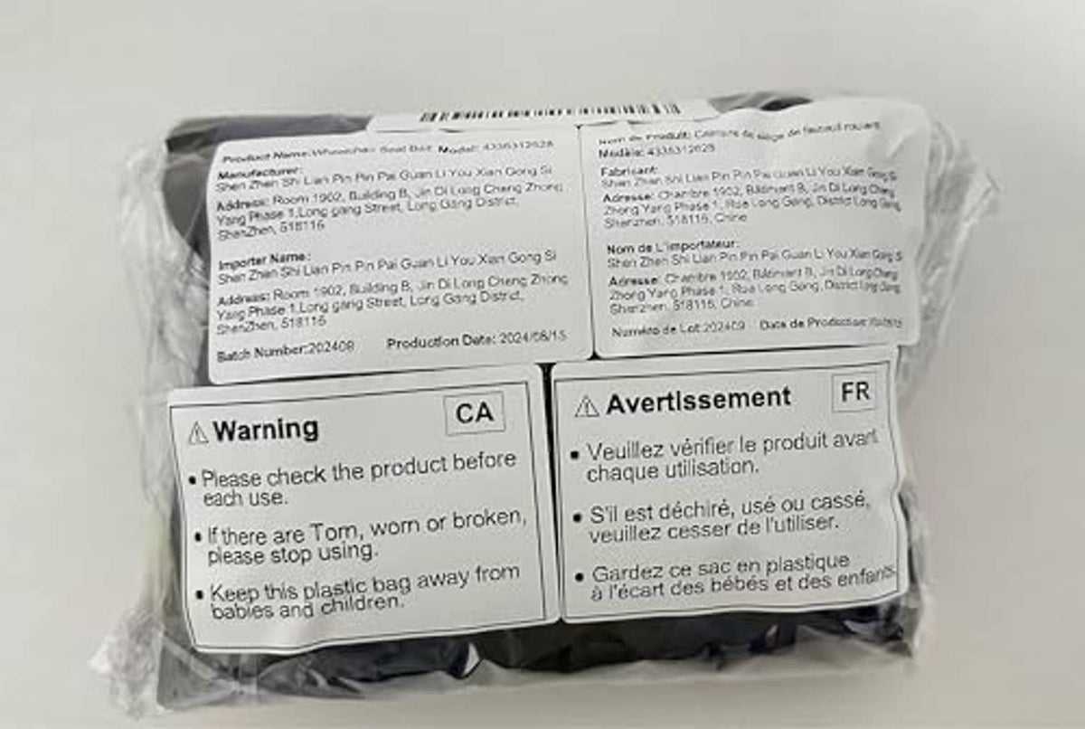 Wheelchair seatbelt restraint packed in clear plastic with warning labels