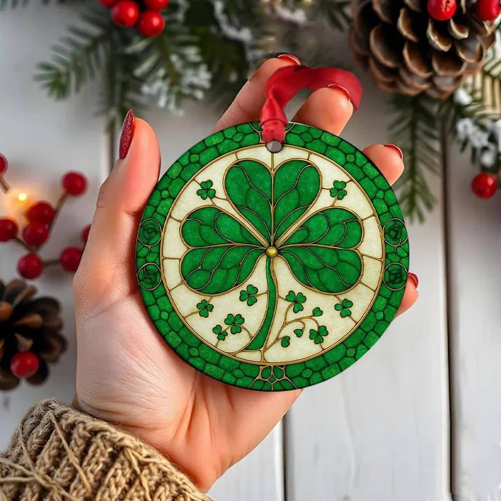Green ceramic shamrock ornament with red ribbon, held in a hand for display