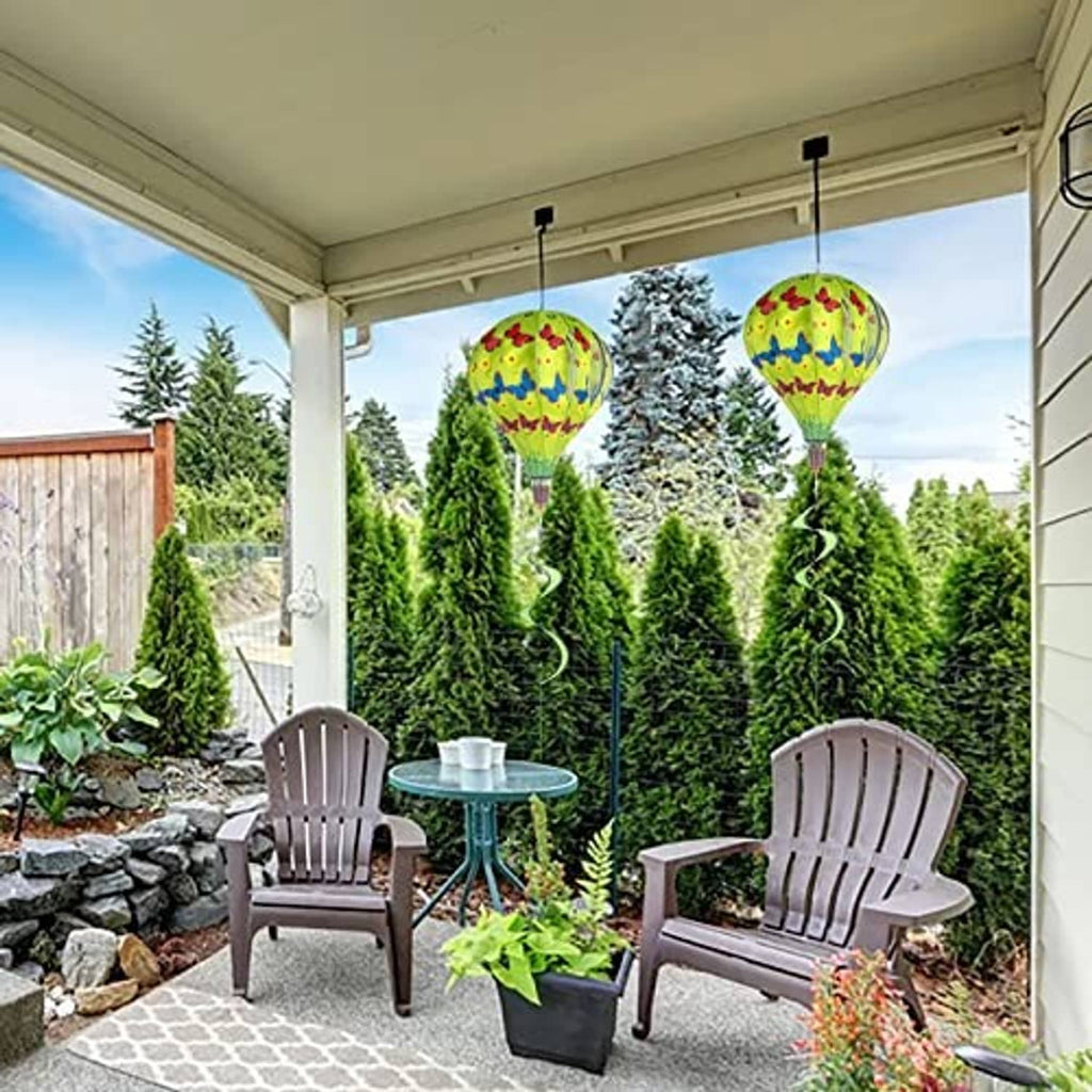 Garden patio decor featuring three green butterfly hot air balloon wind spinners hanging