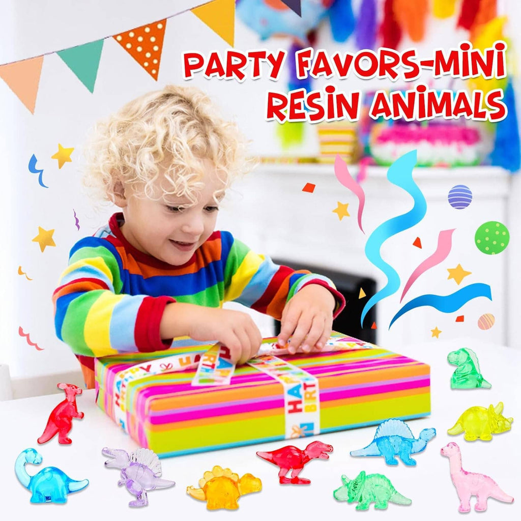 Small multicolored mini resin dinosaur figures around a gift as a child plays