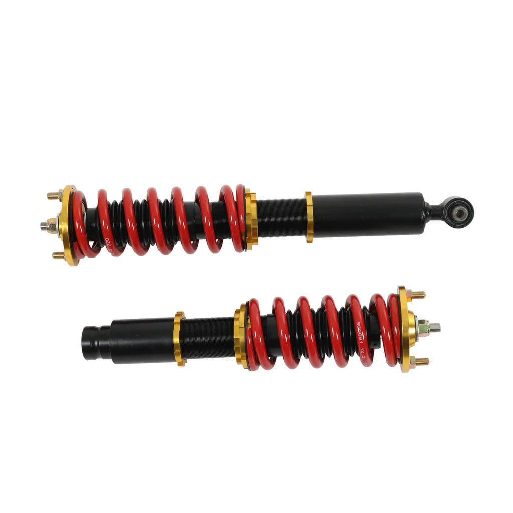 Pair of coilover shocks in side view with red springs and black dampers