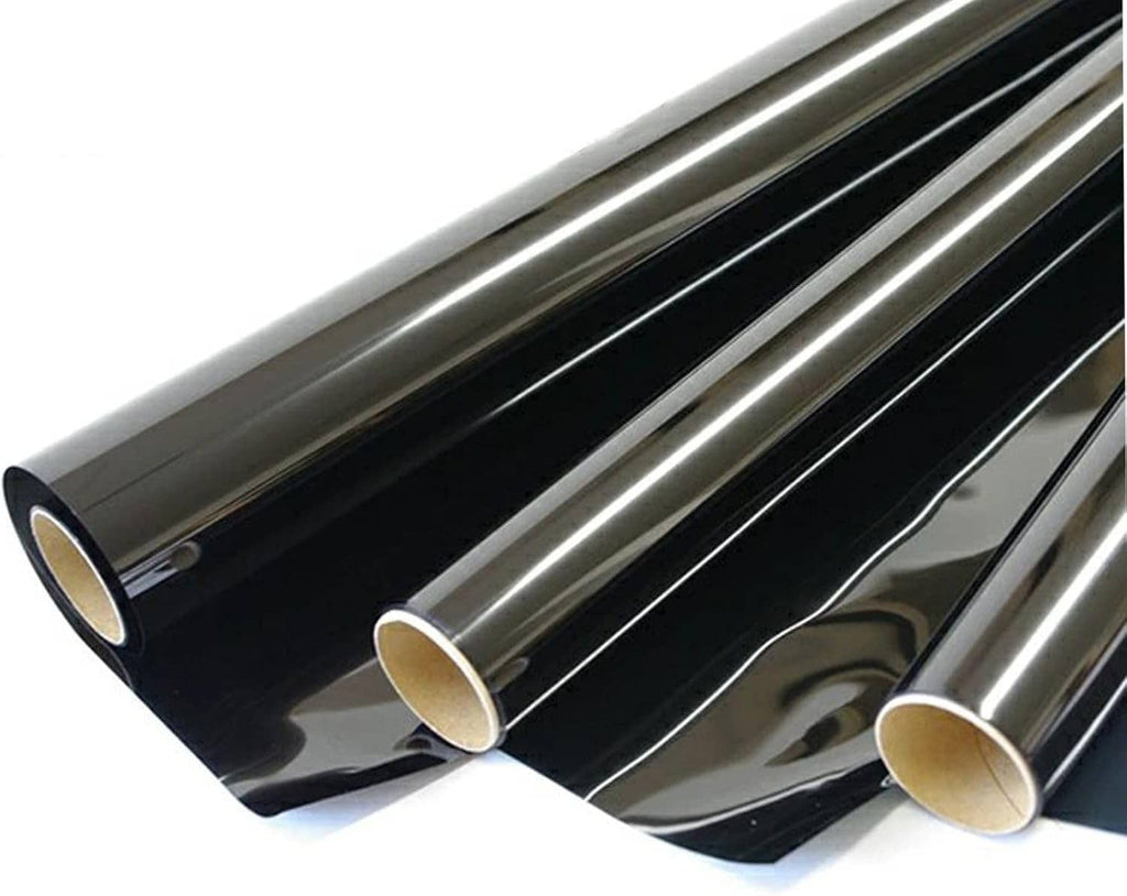 Window tint film roll, dark smoke gray sheet with glossy surface and protective backing.