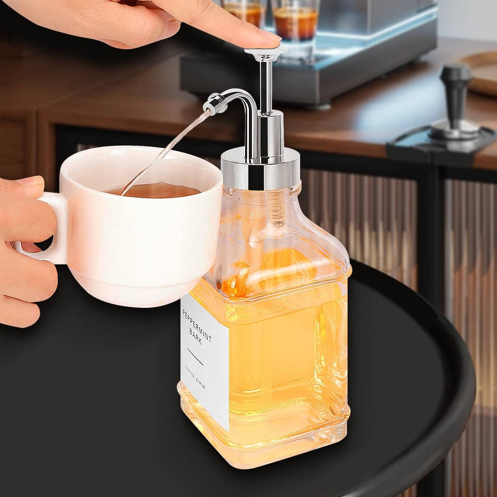 Coffee syrup dispensed by chrome pump into a cup from an amber glass bottle