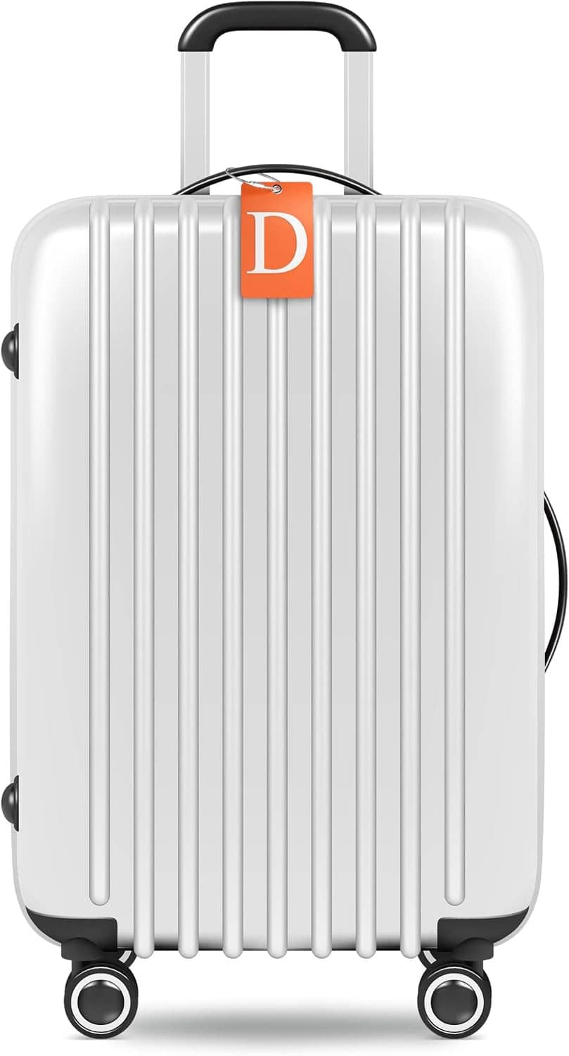 Orange luggage tag with initial D on white suitcase handle