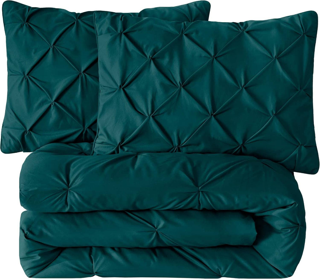 Folded teal comforter set with two diamond tufted shams