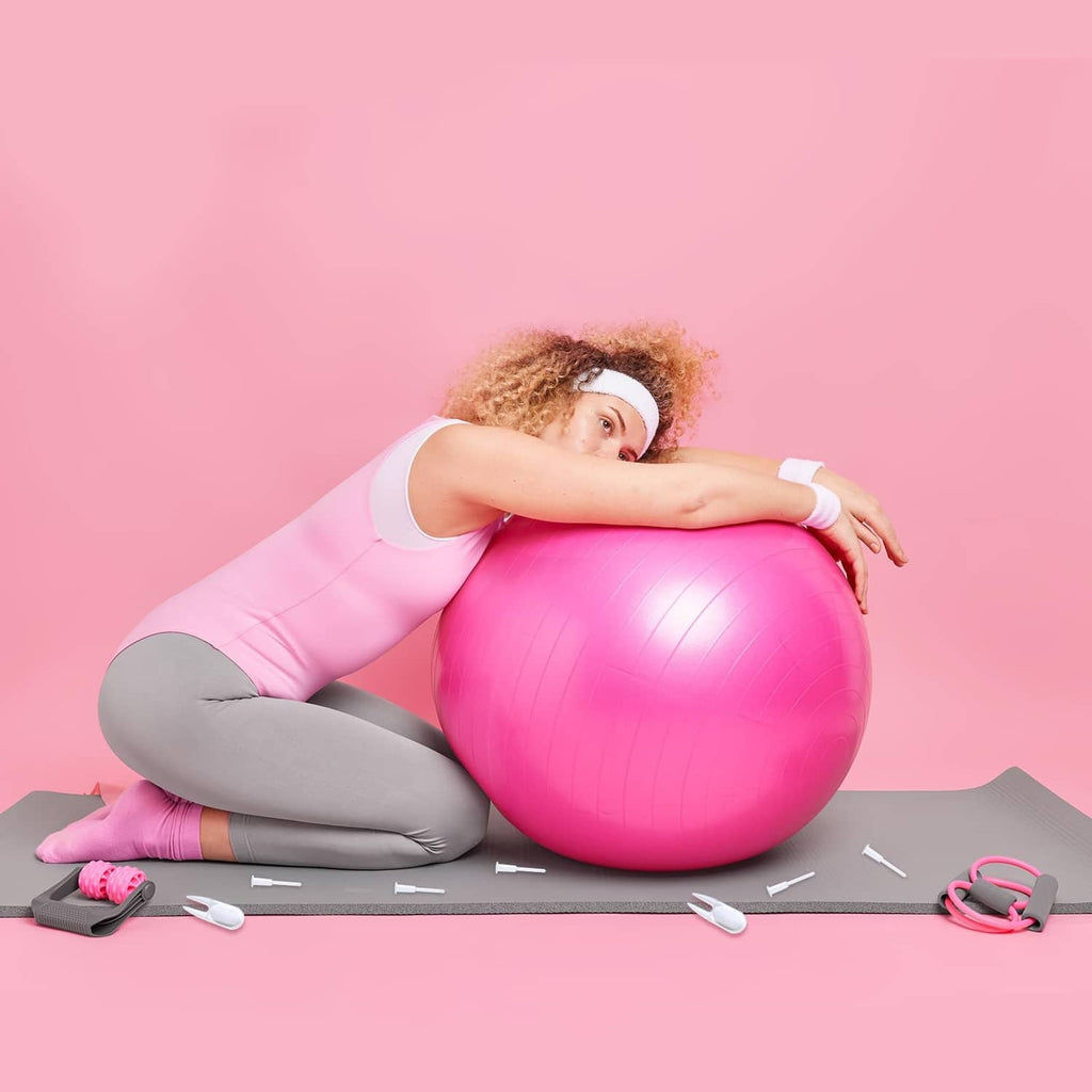 White replacement plug tips near pink exercise ball and pump tools
