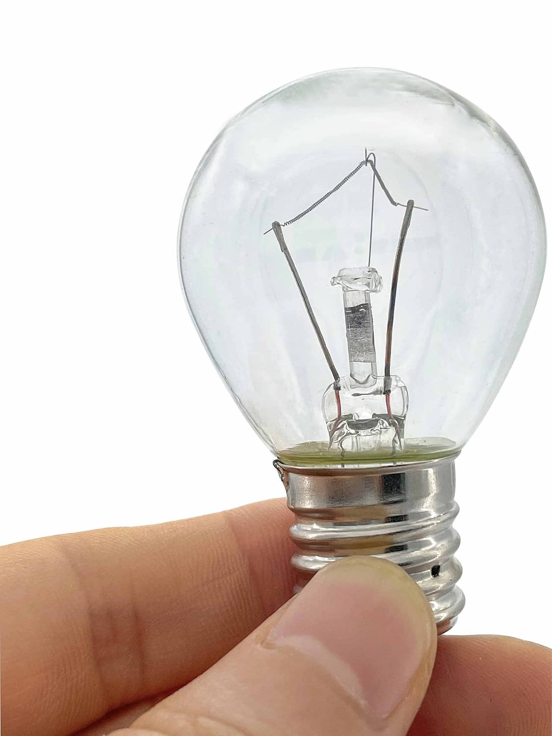 Clear lava lamp bulb held in fingers, showing filament and metal screw base