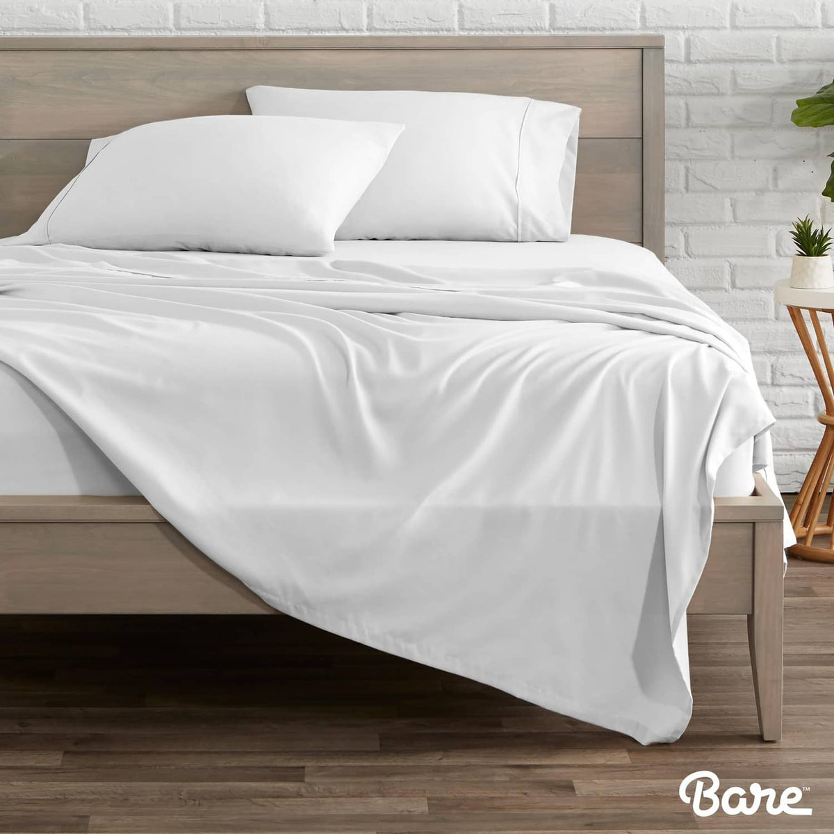 White flat sheet set on a Twin XL bed with matching pillows