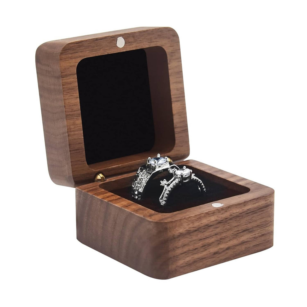 Square solid wood ring box with hinged lid, open to two black velvet ring slots