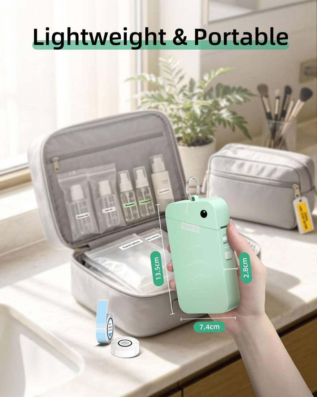 Green portable label maker held near open travel organizer case and tape roll