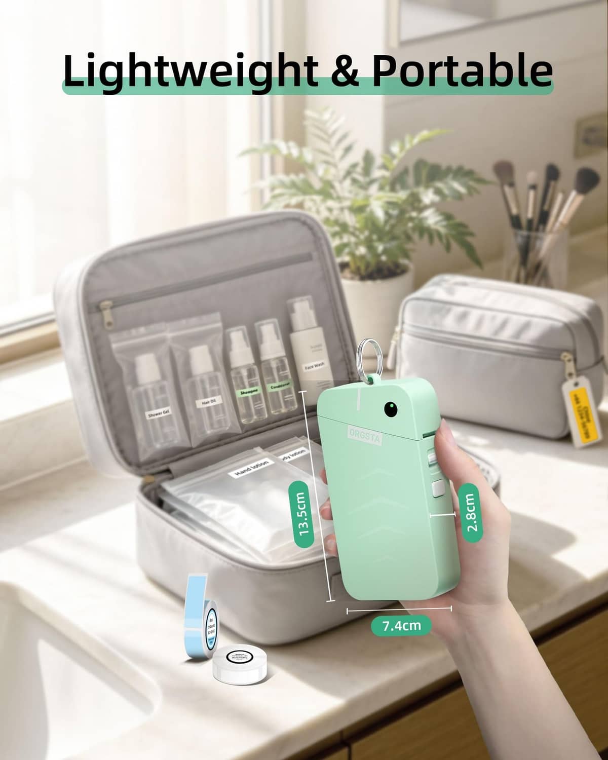 Green portable label maker held near open travel organizer case and tape roll