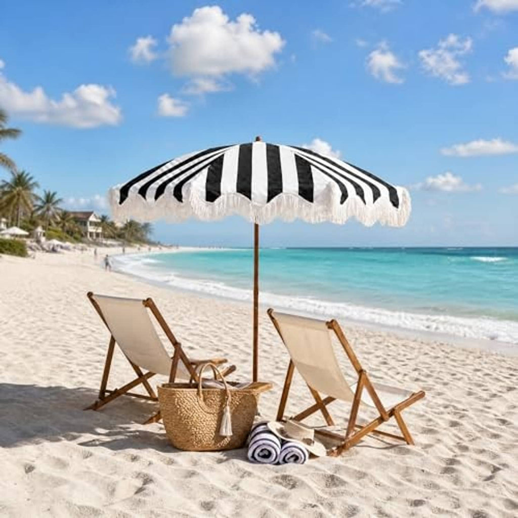 Black-and-white striped patio umbrella with white fringe and wooden center pole